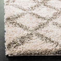 a white rug with grey and black designs on it