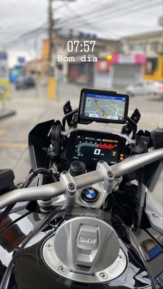 a close up of the handlebars on a motorcycle with a gps device attached to it