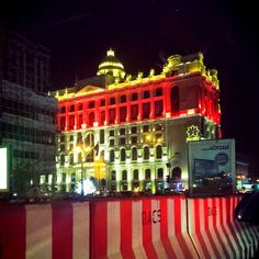 a large building lit up with red and yellow lights