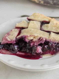 a slice of blueberry pie on a white plate