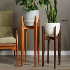 two wooden chairs next to each other with potted plants on them and labeled names