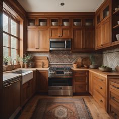 a kitchen with wooden cabinets and stainless steel stove top oven, dishwasher and sink