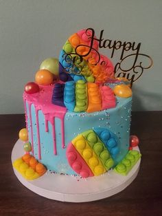 a birthday cake decorated with colorful icing and candies