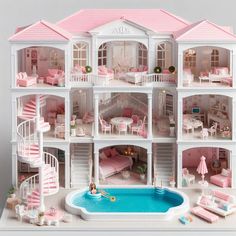 a doll house with a pool in the middle and lots of furniture on top of it