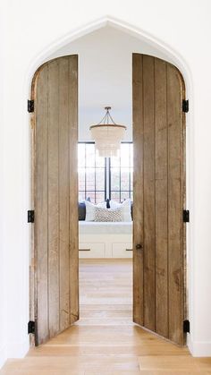 an open wooden door leading to a bedroom