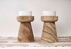 two wooden salt and pepper shakers sitting on top of a tablecloth covered surface