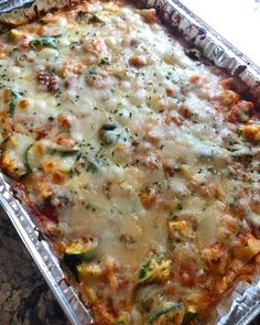 a casserole dish with cheese and vegetables in it