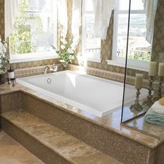 a bath tub sitting next to a window in a bathroom