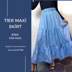 a woman wearing a blue skirt and black top with the words tier maxi skirt sizes xxs - xxxl beginner sewing pattern