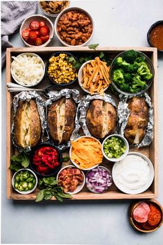 a wooden tray filled with different types of food