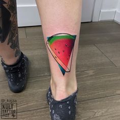 a watermelon slice tattoo on the right leg is shown in front of a woman's legs