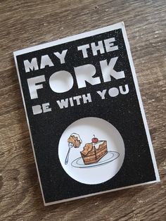 a white plate with a piece of cake on it and the words may the fork be with you