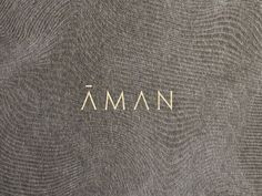 the word aman written in white on a gray background