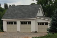 a two car garage is shown in front of some trees