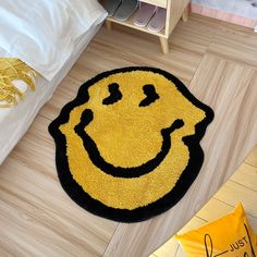 a smiley face rug on the floor in a bedroom