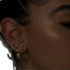 a close up of a person with ear piercings on their ears and behind the ear