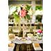 a blurry photo of a dining room table and chairs with flowers in vases