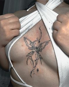 a woman's breast with a flower tattoo on it