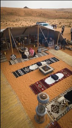 tents set up in the desert with carpets and rugs