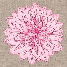 a pink flower is shown on the side of a piece of fabric with stitching