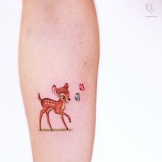 a small deer tattoo on the leg