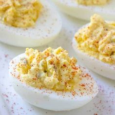 deviled eggs with mustard sprinkled on them