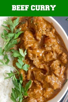 beef curry with white rice and parsley garnish in a bowl on a table