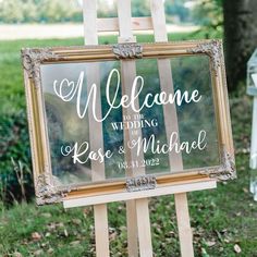 a welcome sign is placed on an easel for the guests to take pictures in