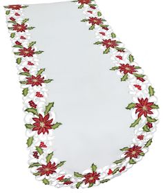 a white plate with red and green poinsettis on the edge is shown