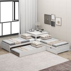 a living room with white furniture and rugs on the floor, including an ottoman bed