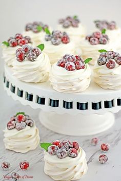 a white cake topped with whipped cream and raspberries