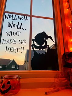 a window with halloween decorations in it and a sign that says, well well what have we here?