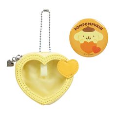 a yellow heart shaped purse with a keychain attached to it and a button that says pompompuin