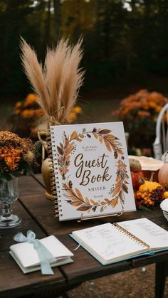 a guest book sitting on top of a table next to pumpkins and other decorations