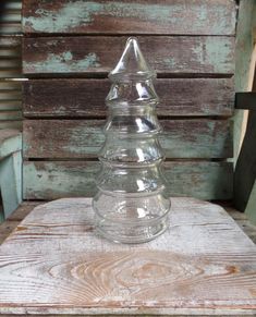 a glass bottle sitting on top of a wooden table