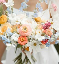 a bride holding a bouquet of flowers in her hands