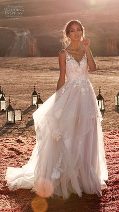 a woman in a white wedding dress standing on a red carpet with lanterns behind her