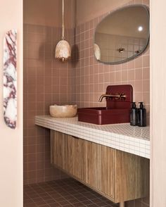 a bathroom with a sink, mirror and soap dispenser on the counter