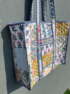 a multicolored bag hanging on the side of a building