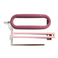 a pink and white toothbrush holder next to a pair of scissors on a white background