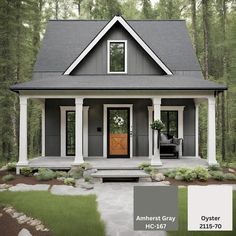 a gray house with white trim and wooden doors in the front yard, surrounded by trees