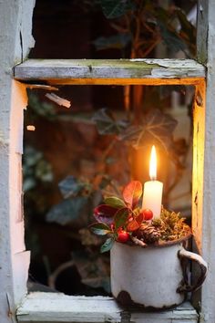 a candle that is sitting in a window sill