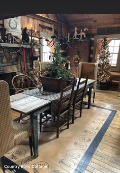 a dining room table with chairs and a potted tree in the middle of it