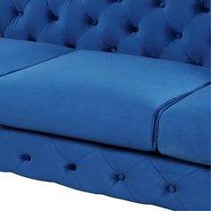 a blue couch is shown with buttons on the armrests and an open buttoned back