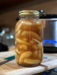 a jar filled with liquid sitting on top of a wooden table