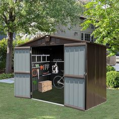 an outdoor storage shed with its doors open and tools in the garage compartment on the grass