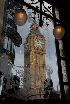 the big ben clock tower seen through a window in london, england at dusk or dawn