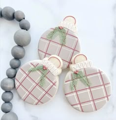 three decorated cookies sitting on top of a table