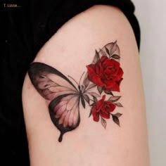 a woman's arm with a butterfly and roses tattoo on it