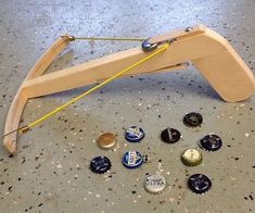 a wooden bench with several different types of buttons on the ground next to each other